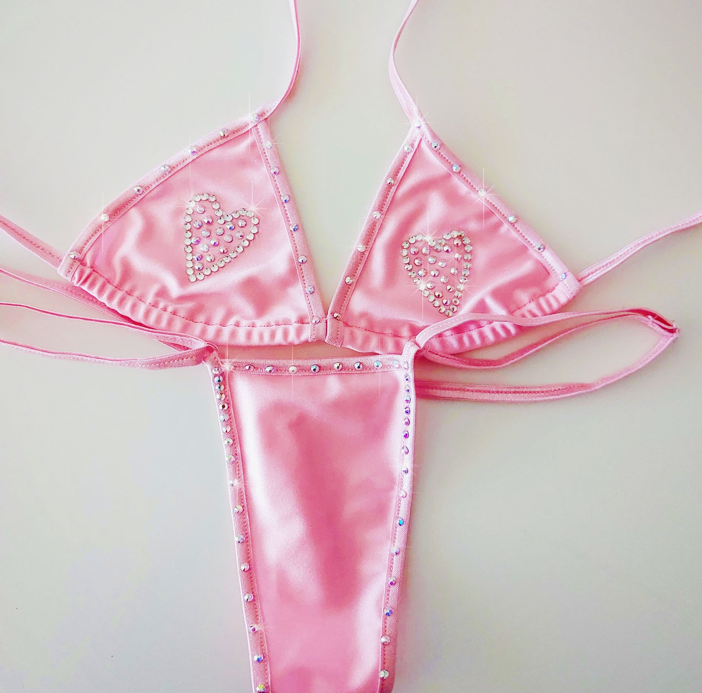 Product shot of Baby Pink rhinestone heart bikini with adjustable straps on a white background.