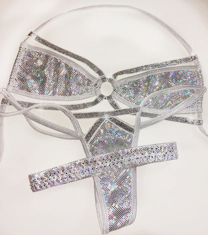 A three-piece white and silver hologram bikini costume set including a bra top, thong, and garter for leg, displayed on a plain white background.