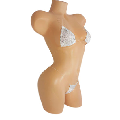Product shot of White mesh invisible strap string bikini thong covered in diamond rhinestones on a white background.