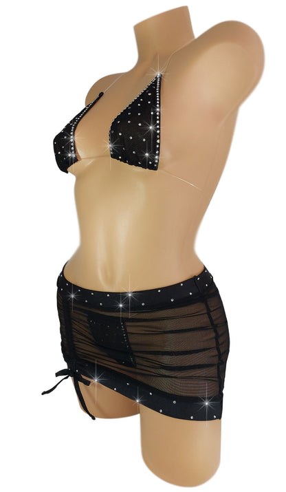 Black mesh halter top with rhinestones and matching micro mini skirt on a mannequin.