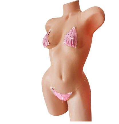 Mannequin wearing a pink polka dot bikini on a white background