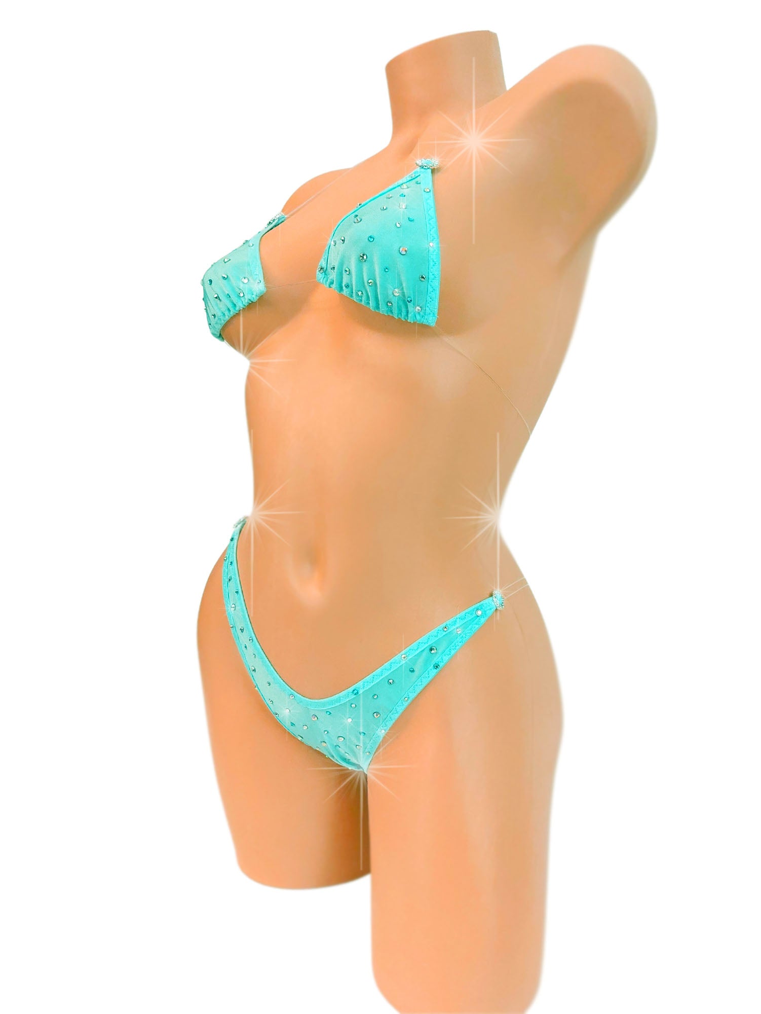 Rhinestone covered Mint colored bikini with clear string ties on a mannequin.