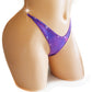 Irridescent purple thong with color changing rhinestones.