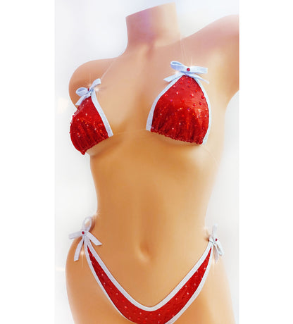 Bikini in Red hologram with white sparkle trim and bows, covered in red rhinestones with clear elastic invisible straps, on a mannequin.
