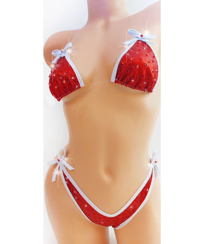 Bikini in Red hologram with white sparkle trim and bows, covered in red rhinestones with clear elastic invisible straps, on a mannequin.