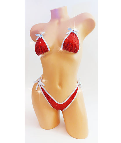Bikini in Red hologram with white sparkle trim and bows, covered in red rhinestones with clear elastic invisible straps, on a mannequin.