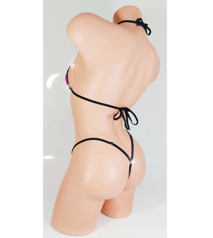 Thong bikini with pink rhinestones on a sexy mannequin, rear view.