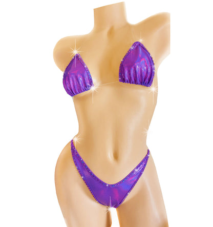 Clear elastic invisible strap thong bikini in Purple reflective spandex with purple blue rhinestones, on a mannequin. 