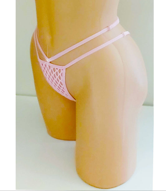 A pink fishnet g-string adjustable strap thong displayed on a tan mannequin torso against a plain light background. The set includes a halter-style triangle top with a front tie and matching strappy low-rise bottoms in fishnet. displayed on a tan mannequin torso against a plain light background. The bikini features a triangle top with side ties and matching strappy bottoms.