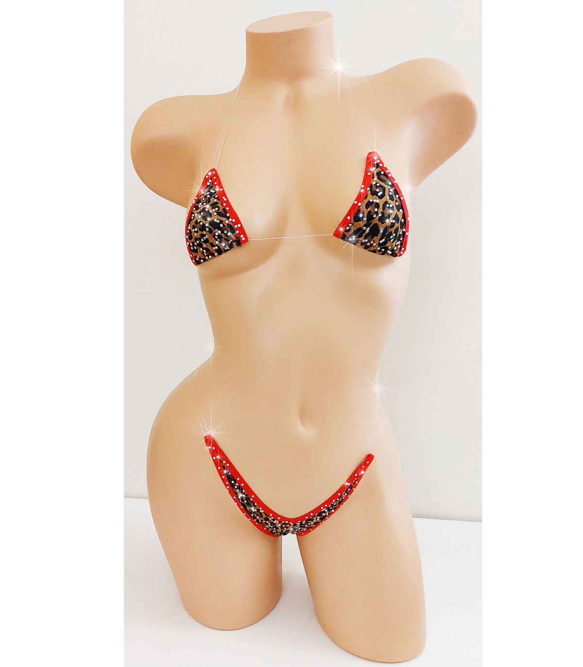 A two-piece bikini set displayed on a beige female mannequin torso. The bikini features a black leopard print pattern with red trim and red side straps, set against a plain white background.