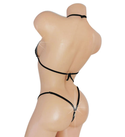 Black strappy lingerie set on a mannequin against a white background