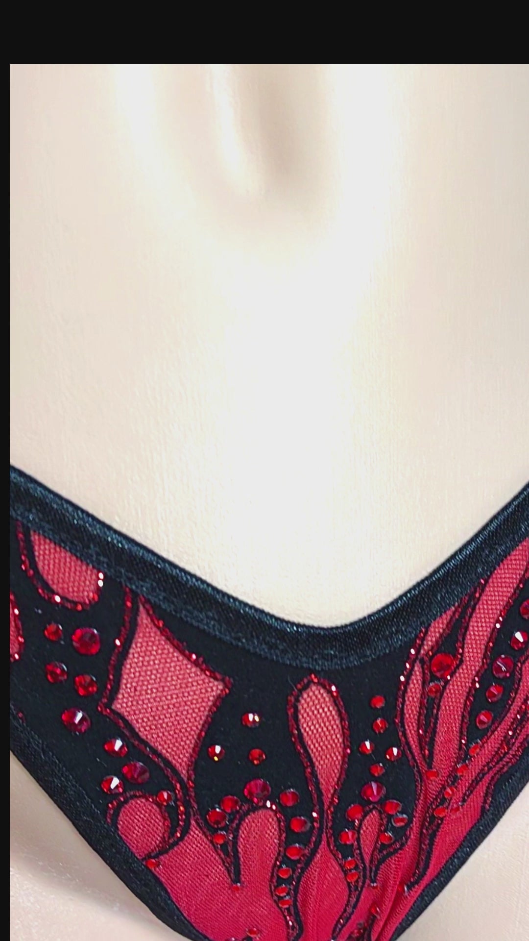 Short video of a red mesh lingerie thong with black and red glitter accents and red rhinestones on a sexy mannequin.