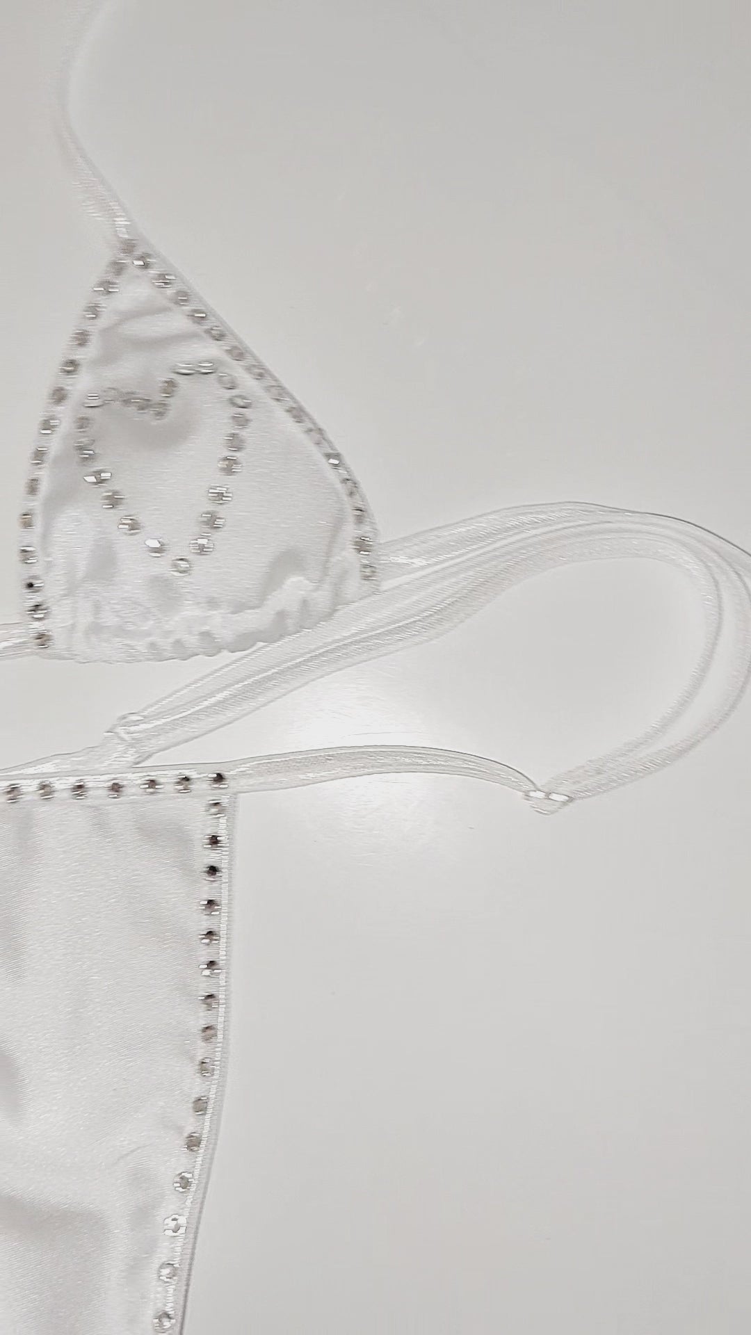 Video of Rhinestone heart white bikini set on a sexy mannequin.