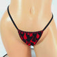 Video of a sexy thong in Red flame fabric with black trim on a curvy mannequin on a white background.
