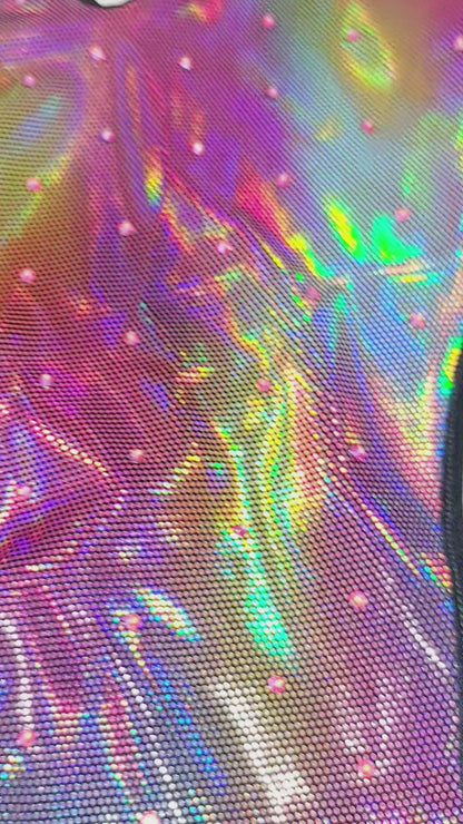 Video of a color changing rainbow hologram one piece on a sexy mannequin on a white background.