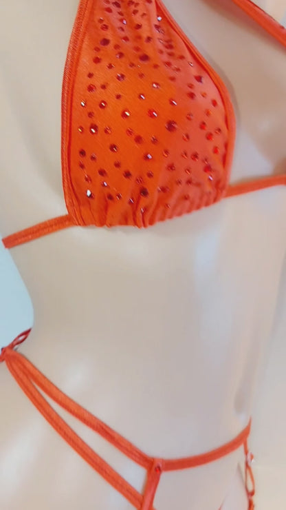 Video of Red rhinestone covered halter crop top, thong and matching garter belt and garters.