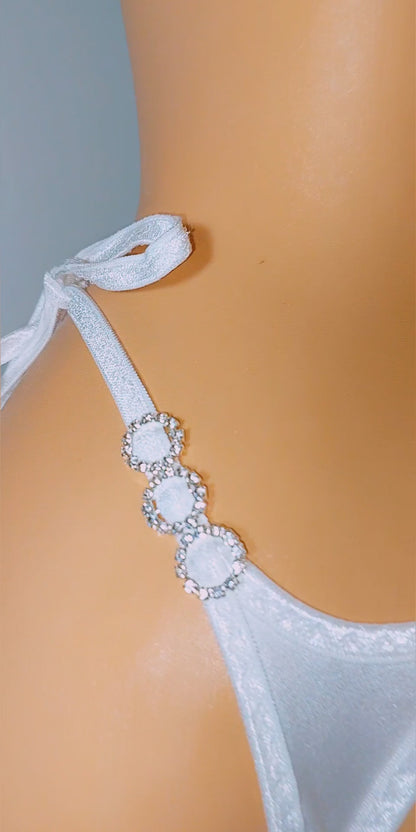 Video of a white tie-side adjustable thong with diamond accents, designed for exotic dancewear and pole dancing.