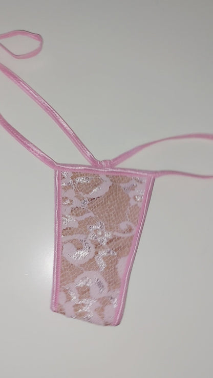 Video of Baby Pink lace thong with side ties on a flat white background and also displayed on a curvy mannequin.