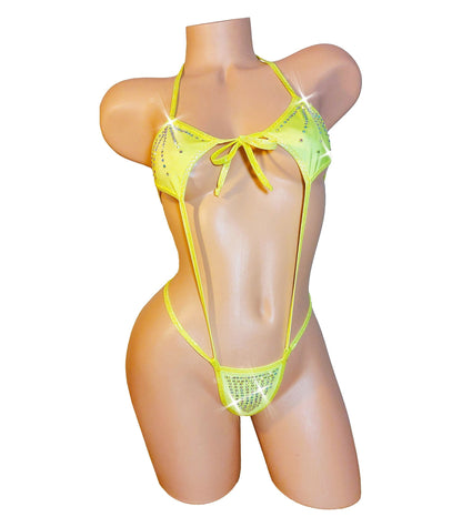 A mannequin torso dressed in a yellow rhinestone-studded one-piece thong bikini with adjustable straps.